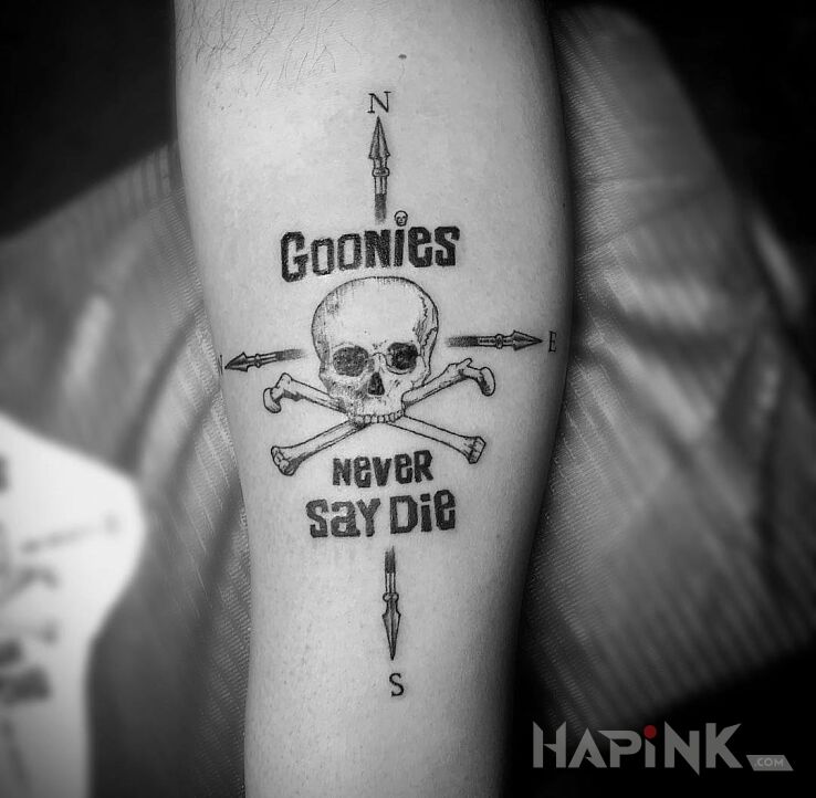 Tattoo Goonies never say die in lettering motif on the forearm
