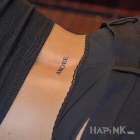 Tattoo Amore on the back motif: lettering style: minimalistic