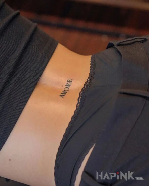 Tattoo Amore in lettering motif and minimalistic style on the back
