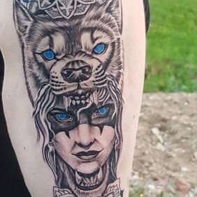 Tattoo She-wolf on the upper arm motif: mandalas style: graphic / illustrative