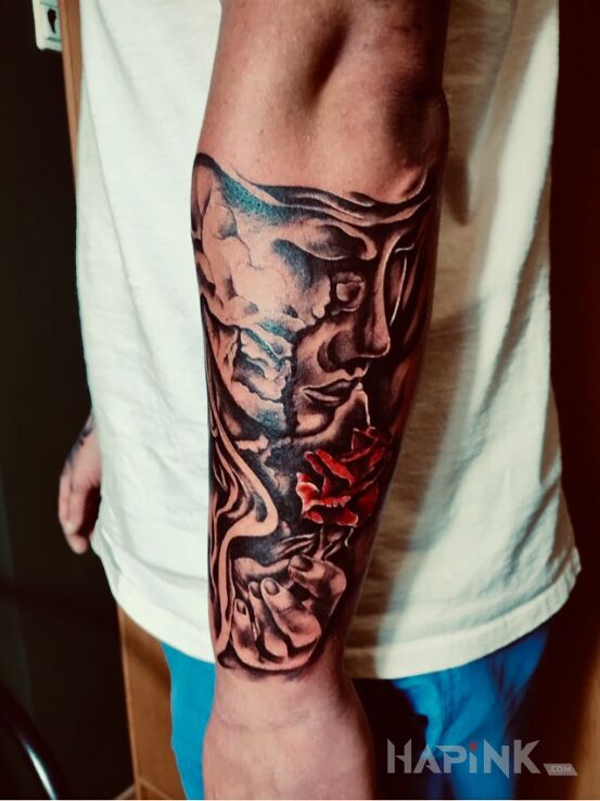 Tattoo Maska in faces motif and realistic style on the upper arm