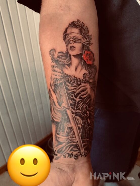Tattoo Temida in characters motif and realistic style on the forearm