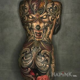 Tattoo The wolf is evil on the buttocks motif: flowers style: neo-traditional