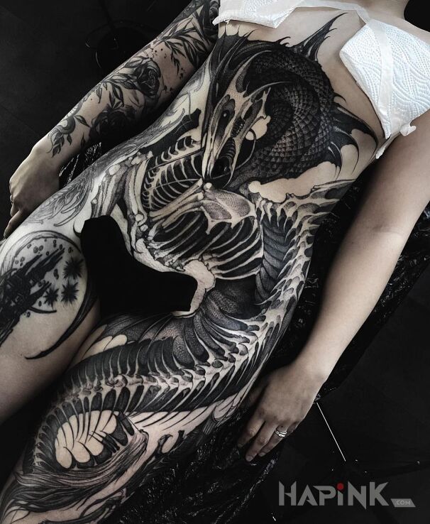 Tattoo Umarły smok in black and gray motif and graphic / illustrative style On the arm