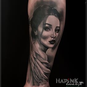 Tattoo Woman covered by a wing on the forearm motif: faces style: realistic