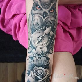 Tattoo Owl with a rose on the forearm motif: flowers style: realistic