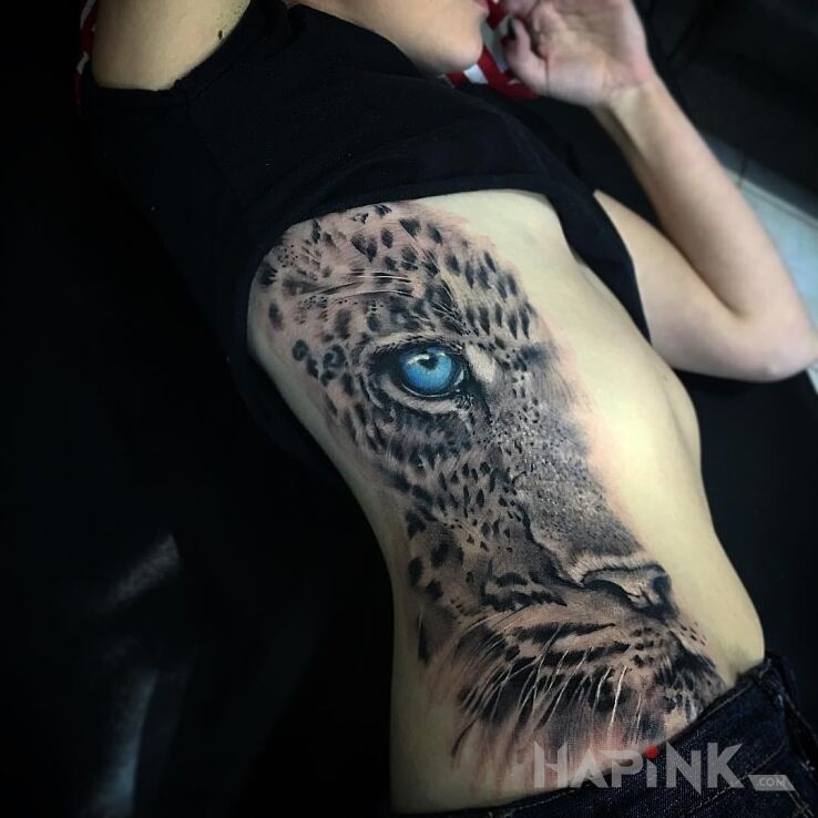 Tattoo Oko lamparta in animals motif and realistic style on the ribs