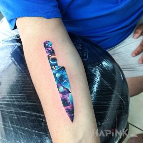 Tattoo Space Knife on the forearm motif: cosmos