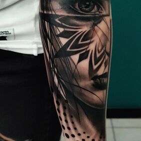Tattoo Half-portrait of a woman with a mandala on the forearm motif: faces style: realistic