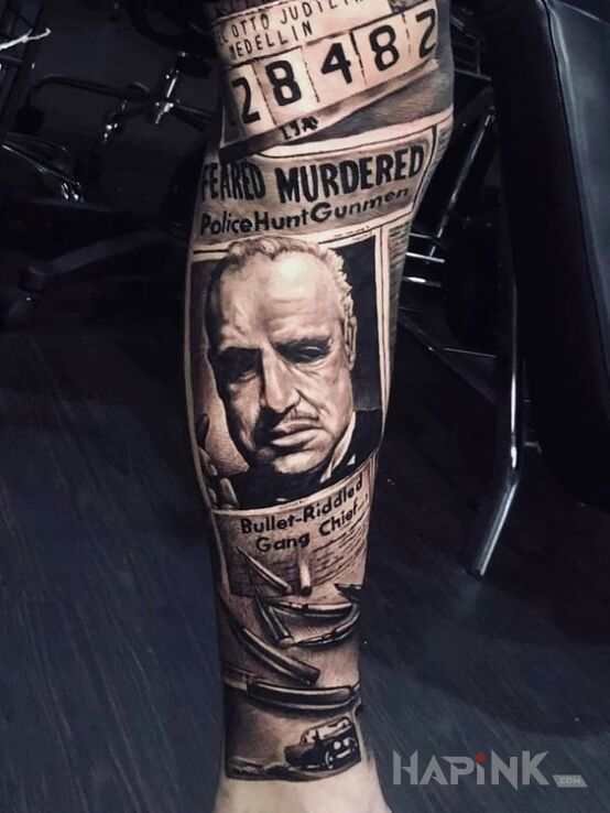 Tattoo Vito Corleone w gazecie in lettering motif and realistic style on the leg
