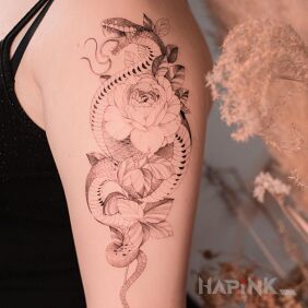 Tattoo @davincisfox Flowers with a snake on the upper arm motif: black and gray style: graphic / illustrative