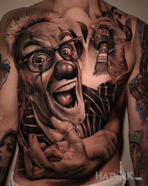 Tattoo Klaun tatuator in faces motif and realistic style on the chest