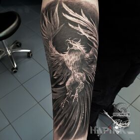 Tattoo Phoenix on the forearm motif: black and gray style: realistic