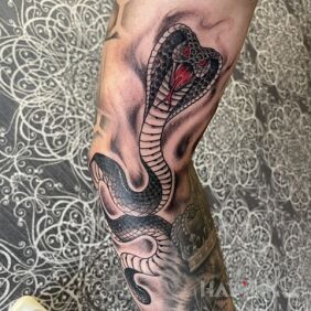 Tattoo Cobra on the bicep motif: animals style: graphic / illustrative
