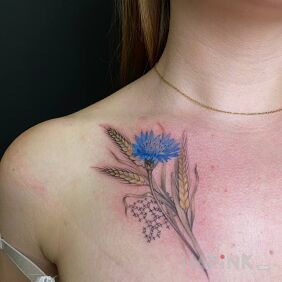 Tattoo Ukrainian patriotic flower on the collarbone motif: colorful style: realistic