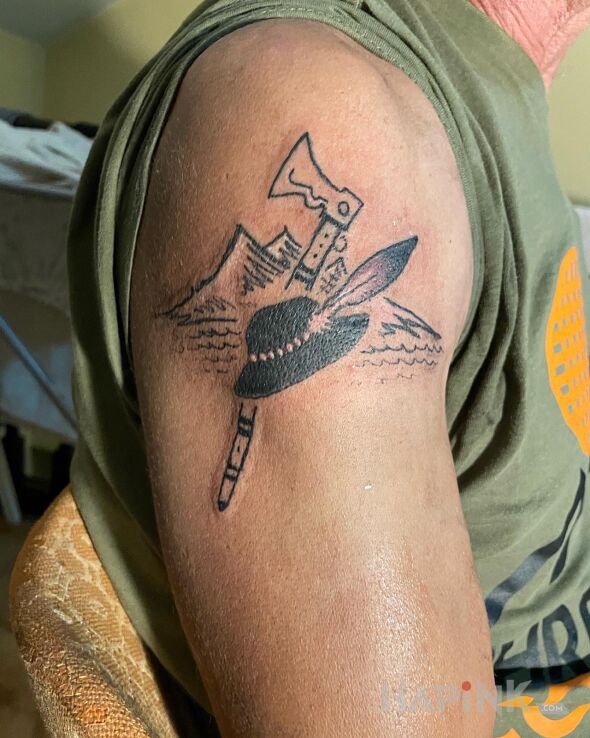 Tattoo Tatuaż góralski in black and gray motif and graphic / illustrative style on the upper arm