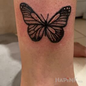 Tattoo Butterfly on the leg motif: black and gray style: graphic / illustrative