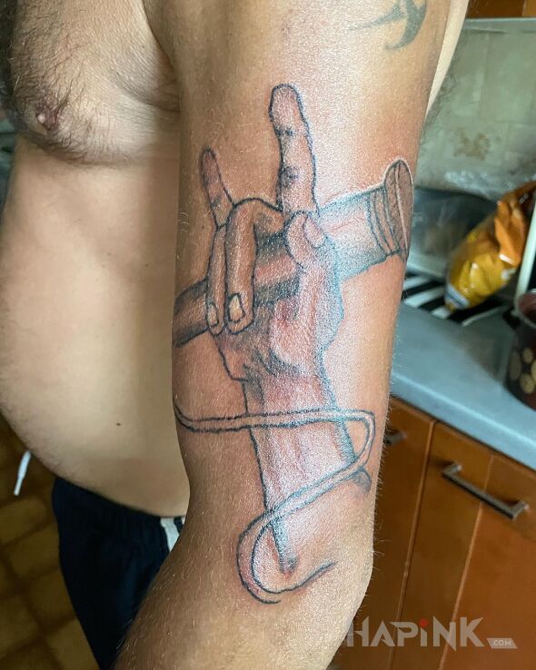 Tattoo Raper in black and gray motif and graphic / illustrative style On the arm