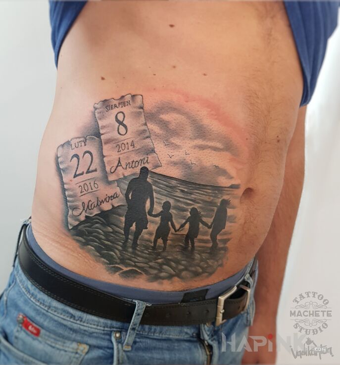 Tattoo Rodzina nad morzem in lettering motif and realistic style on the stomach