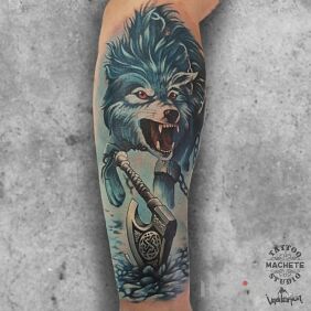 Tattoo Wolf in chains on the forearm motif: colorful style: realistic