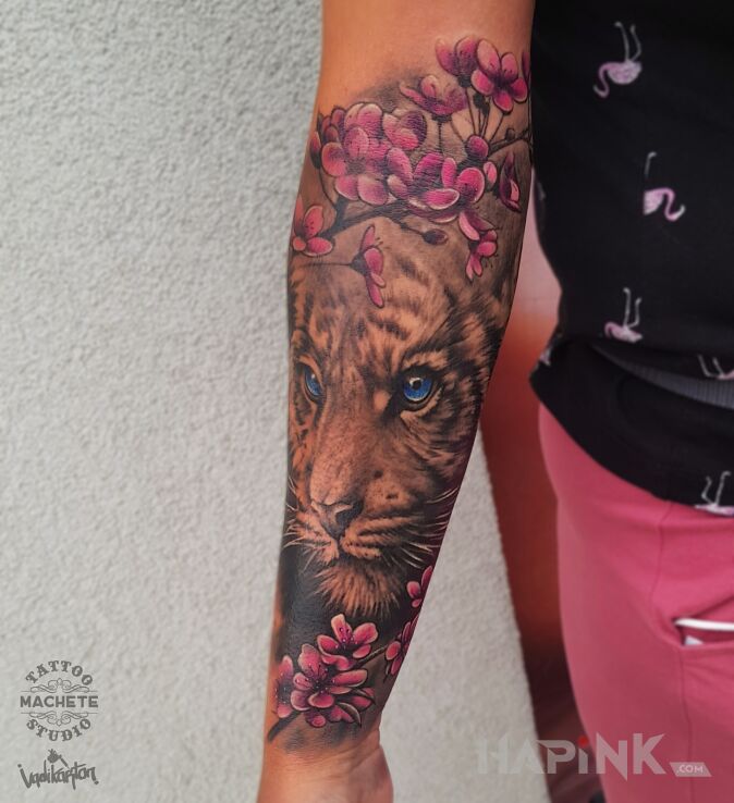 Tattoo Tygrys w różowych kwiatach in flowers motif and realistic style on the forearm