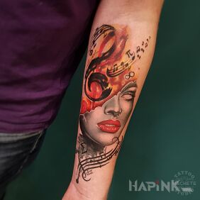 Tattoo Mask with red lips surrounded by music notes On the arm motif: faces style: graphic / illustrative