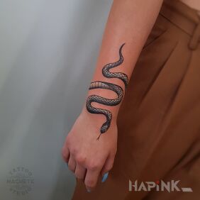 Tattoo A snake wrapped around his arm on the wrist motif: animals style: graphic / illustrative