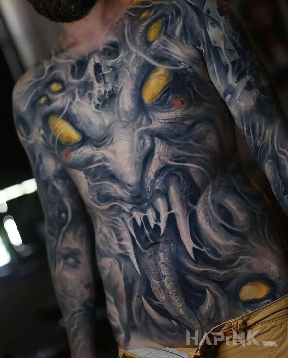 Tattoo Diabelska gęba in faces motif and organic style on the stomach