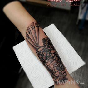 Tattoo Casino games on the forearm motif: black and gray style: realistic