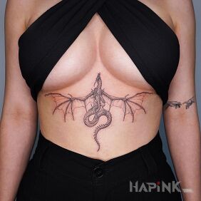 Tattoo Dragon flying towards the head on the stomach motif: black and gray style: graphic / illustrative