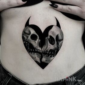 Tattoo Kissing skulls on the stomach motif: black and gray style: realistic