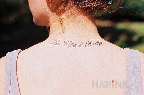 Tattoo Krotki napis in lettering motif on the nape