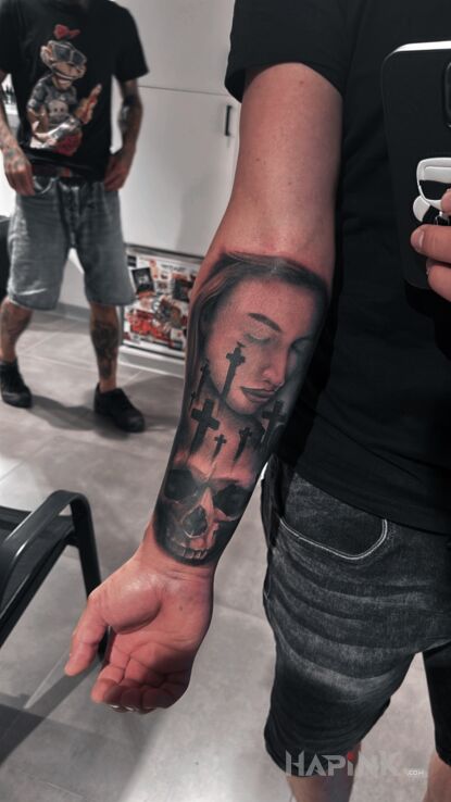 Tattoo Cmentarny motyw in skulls motif and realistic style on the forearm