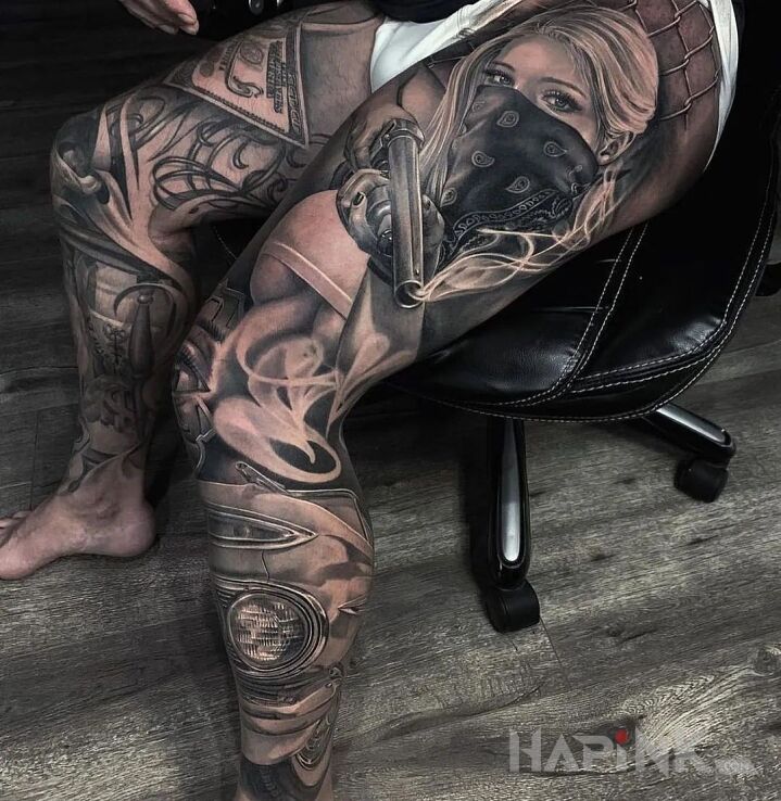 Tattoo Dziewczyna ze strzelbą in faces motif and realistic style on the thigh