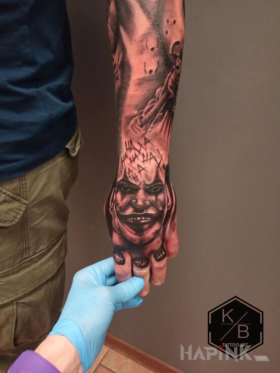 Tattoo Joker in black and gray motif and realistic style On the arm