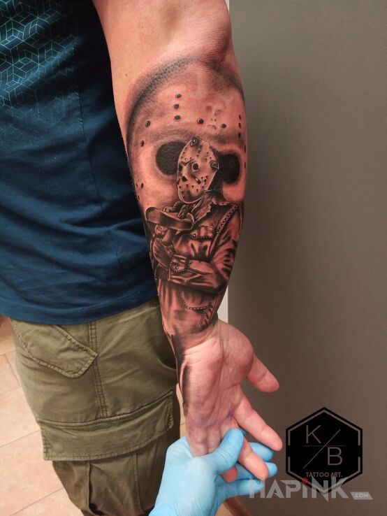 Tattoo Piątej 13stego in dark motif and realistic style On the arm