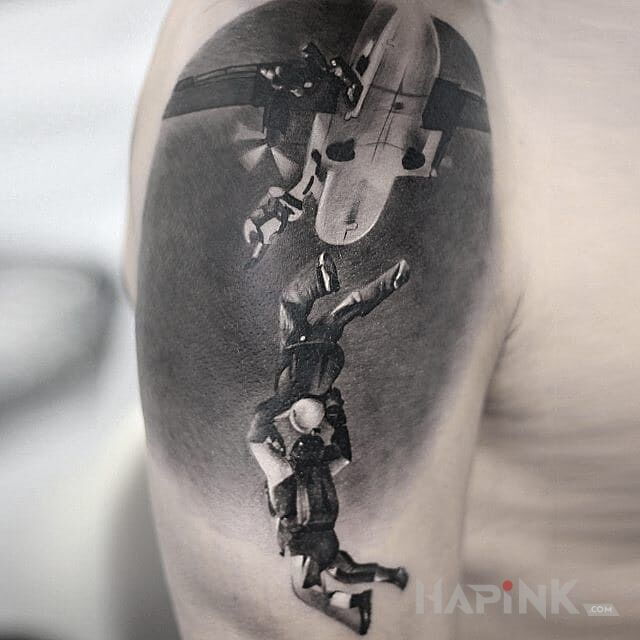 Tattoo W niebie in characters motif and realistic style on the upper arm