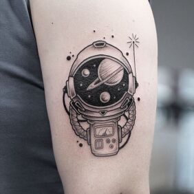 Tattoo ASTRONAUT on the upper arm motif: cosmos style: graphic / illustrative