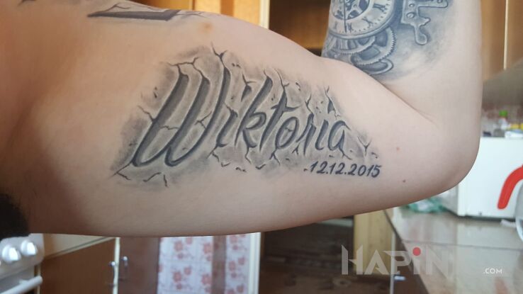 Tattoo Napis in lettering motif on the upper arm
