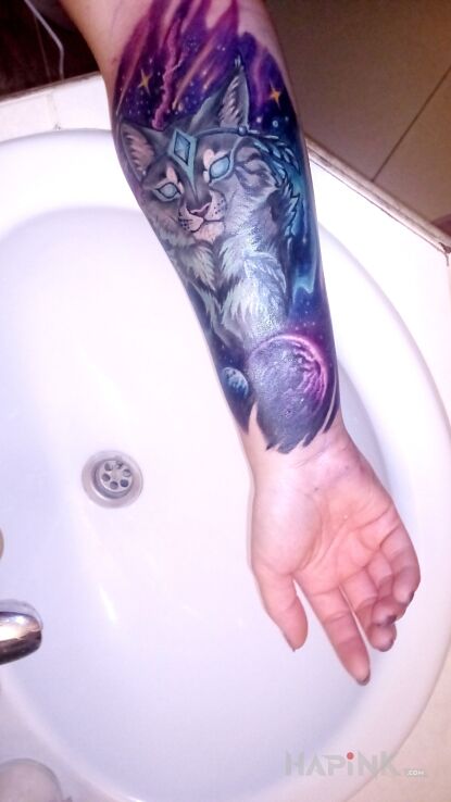 Tattoo Ryś i kosmos in cosmos motif and graphic / illustrative style on the forearm