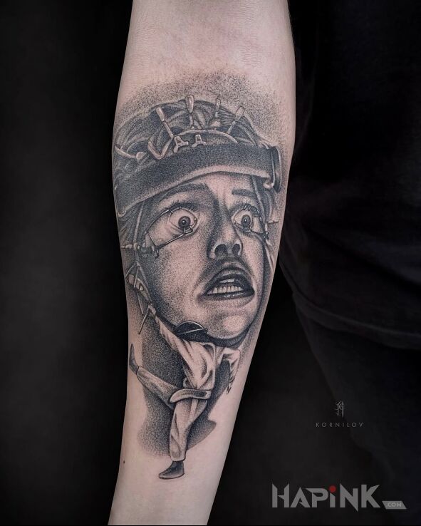 Tattoo Clockwork Orange in dark motif and realistic style On the arm