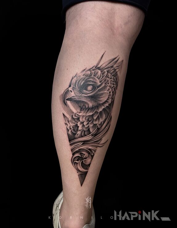 Tattoo Phoenix in black and gray motif and graphic / illustrative style on the calf