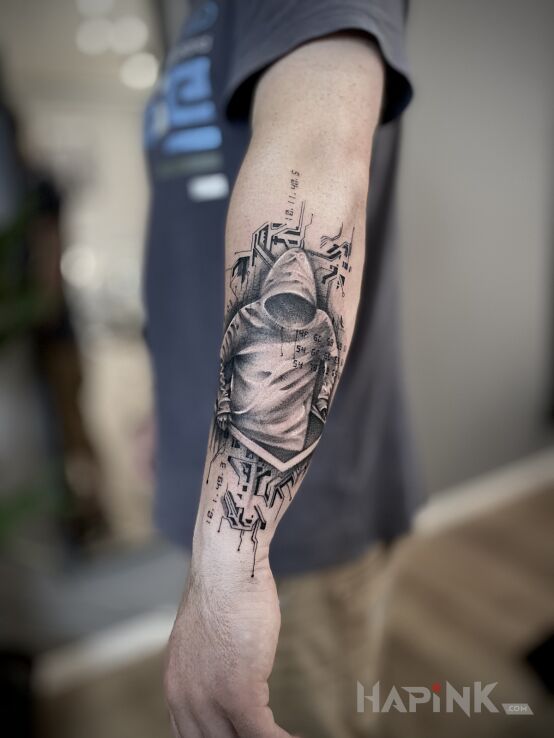 Tattoo A N O N Y M O U S in black and gray motif and graphic / illustrative style On the arm