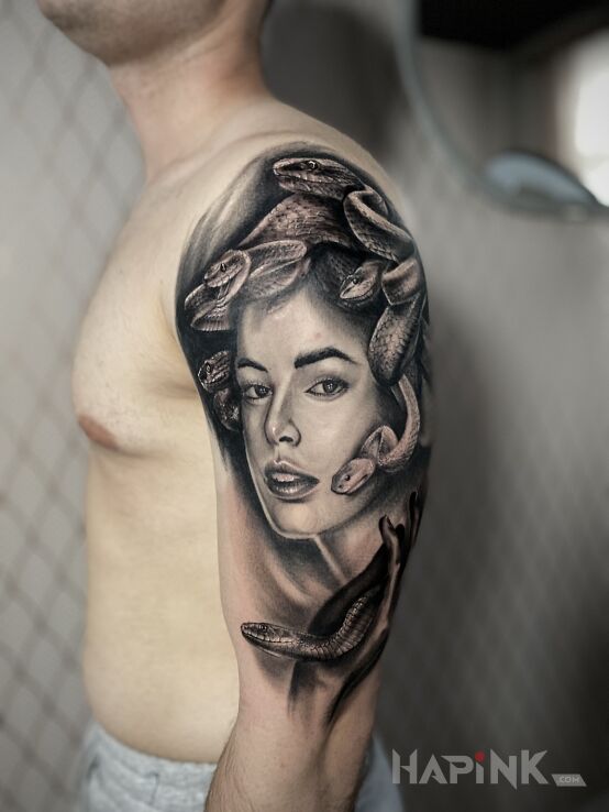 Tattoo M E D U Z A in faces motif and realistic style On the arm