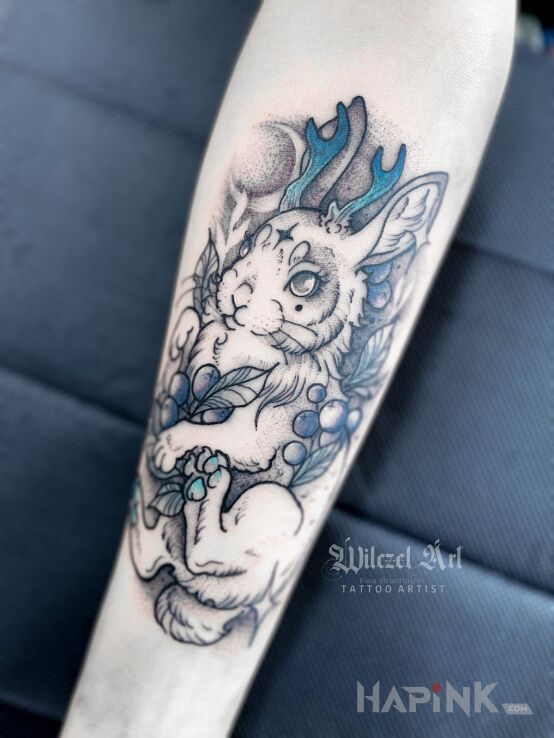Tattoo Jackalope in black and gray motif and graphic / illustrative style On the arm