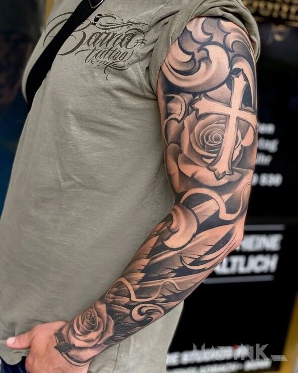 Tattoo Krzyżowiec in wings motif and realistic style on the forearm