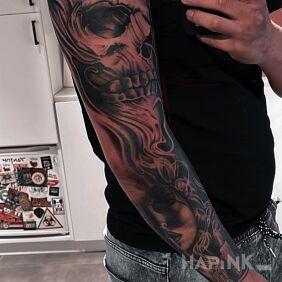 Tattoo Skull on the upper arm motif: faces style: realistic