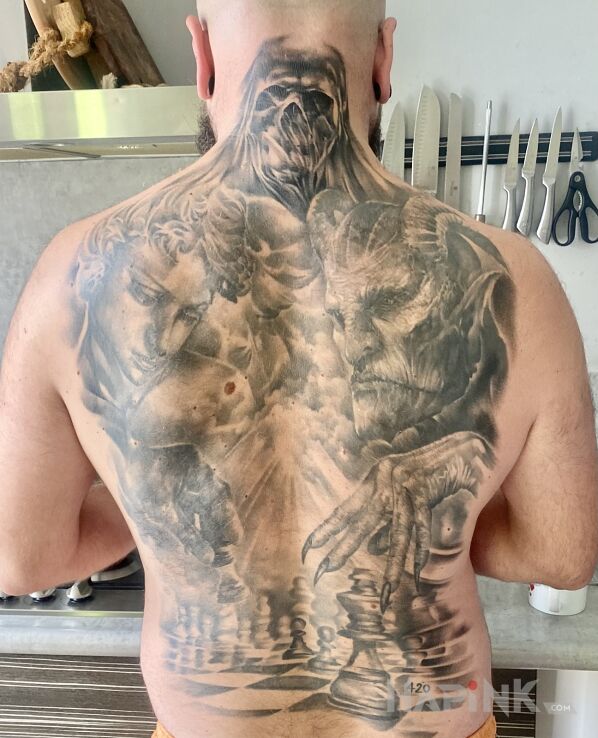 Tattoo Kropka nad i postawiona. in faces motif on the back