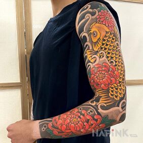 Tattoo Golden koi on the forearm motif: flowers style: japanese / irezumi