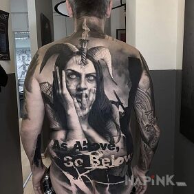 Tattoo Demonic woman on the back motif: lettering style: realistic